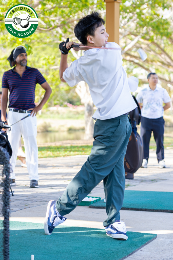 Student practising a golf swing at Prem International School