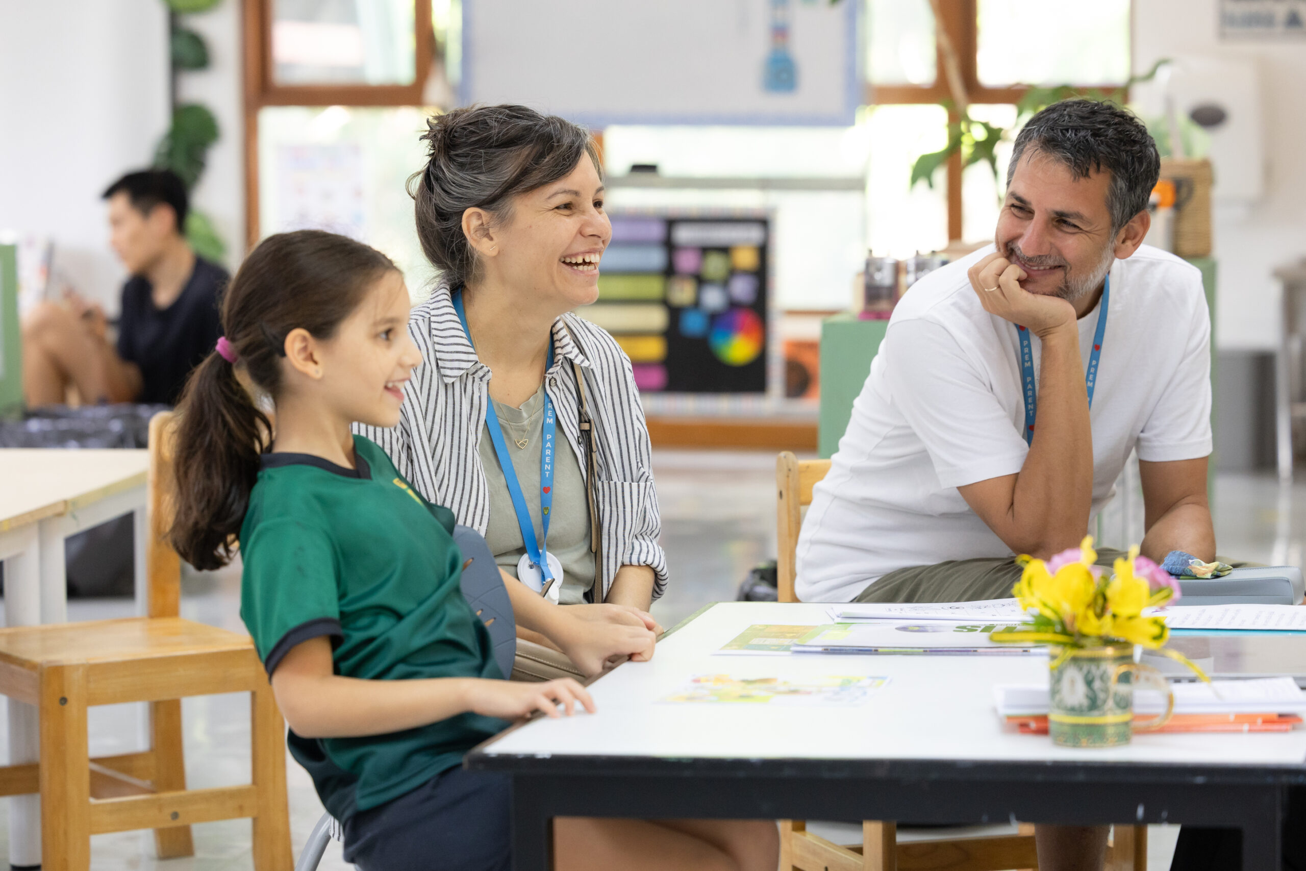 A family speaking with an admission staff member at Prem International School.
